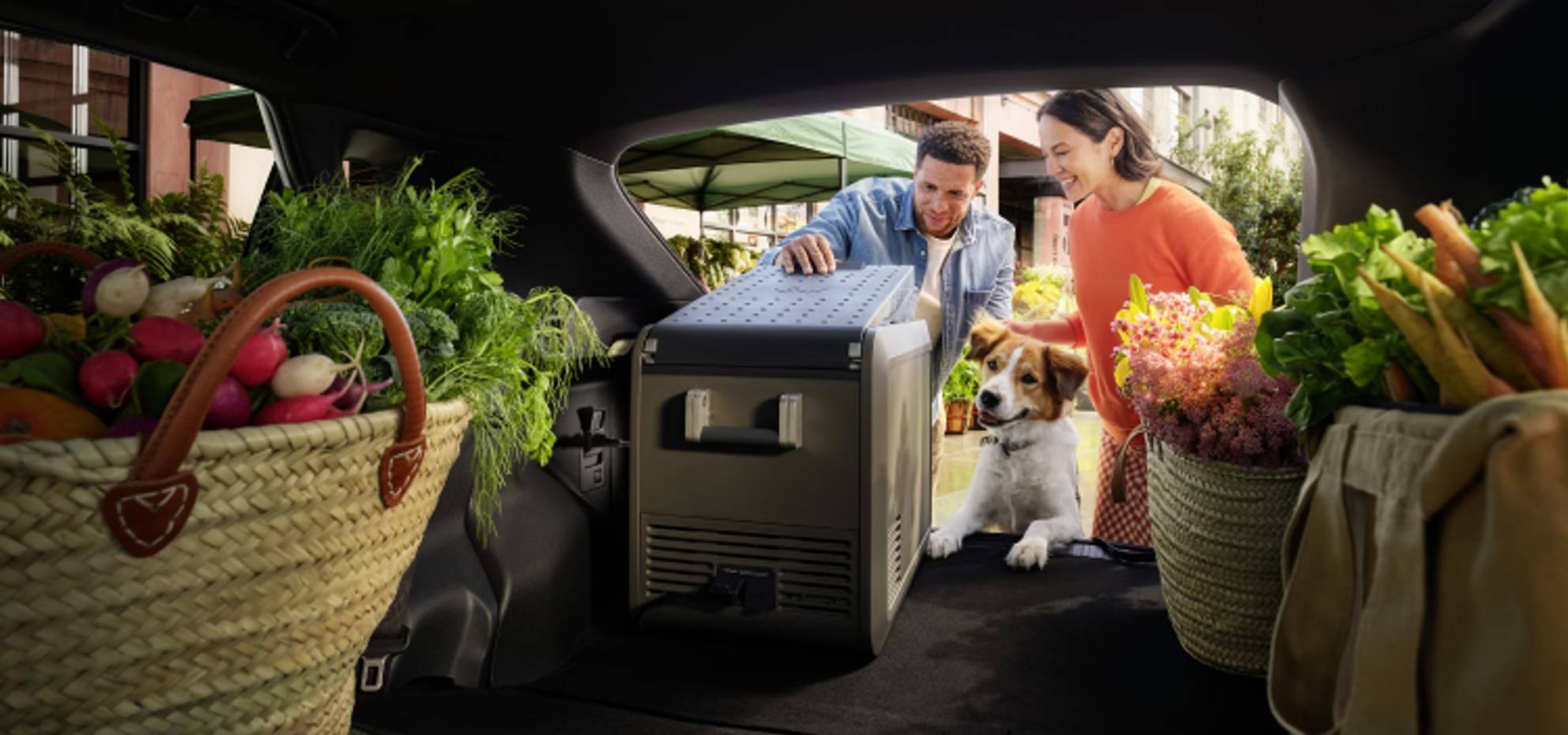 Picture of a family loading groceries into the cargo space of a Toyota bZ.